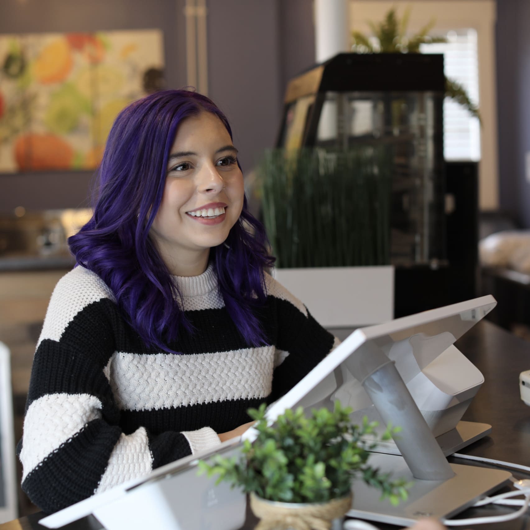 A woman with vibrant purple hair, showcasing a unique and bold hairstyle that stands out in any setting.