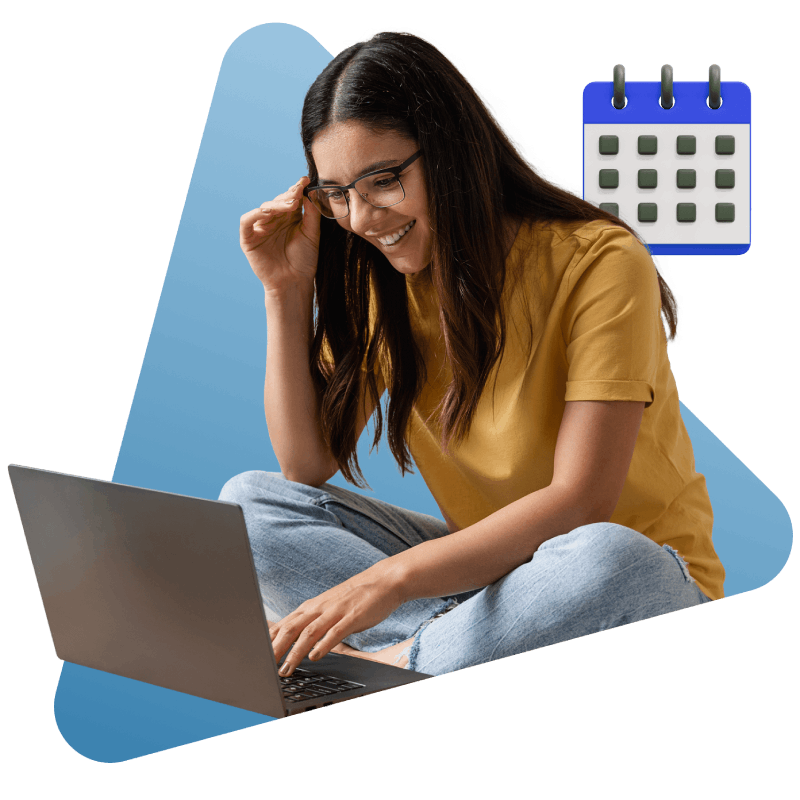 A woman seated on the floor, focused on her laptop, creating a relaxed yet productive atmosphere.