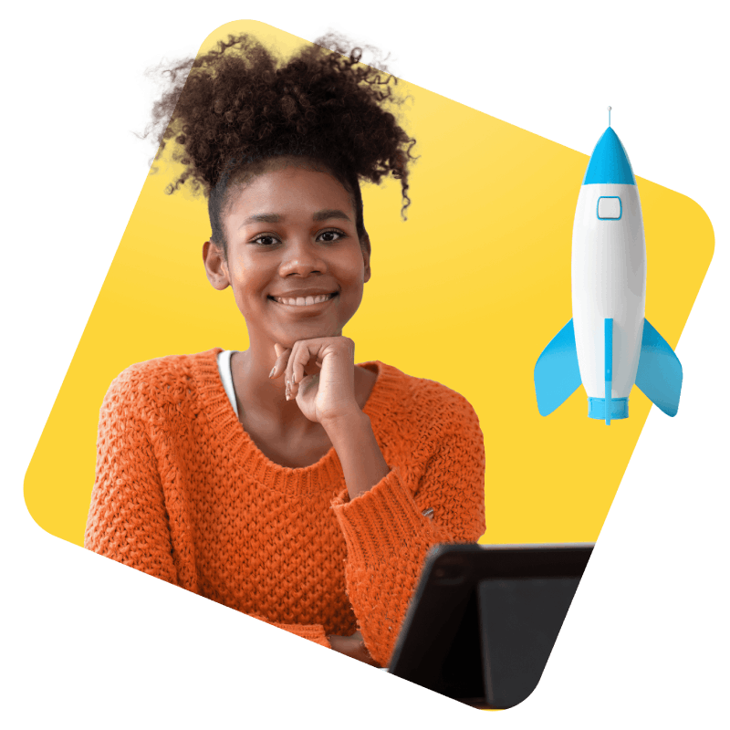 A woman at a desk, focused on her laptop displaying a rocket, symbolizing innovation and ambition in her workspace.