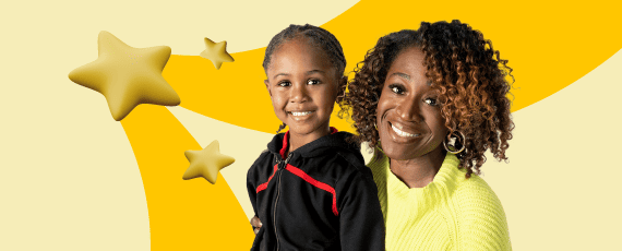 Two smiling children proudly hold up a gold star, showcasing their achievement and joy.