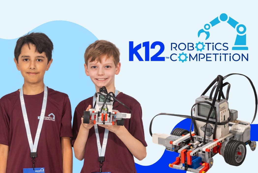 Dos niños muestran con orgullo un robot que crearon para la competencia de robótica K12, rodeados por un fondo azul claro.