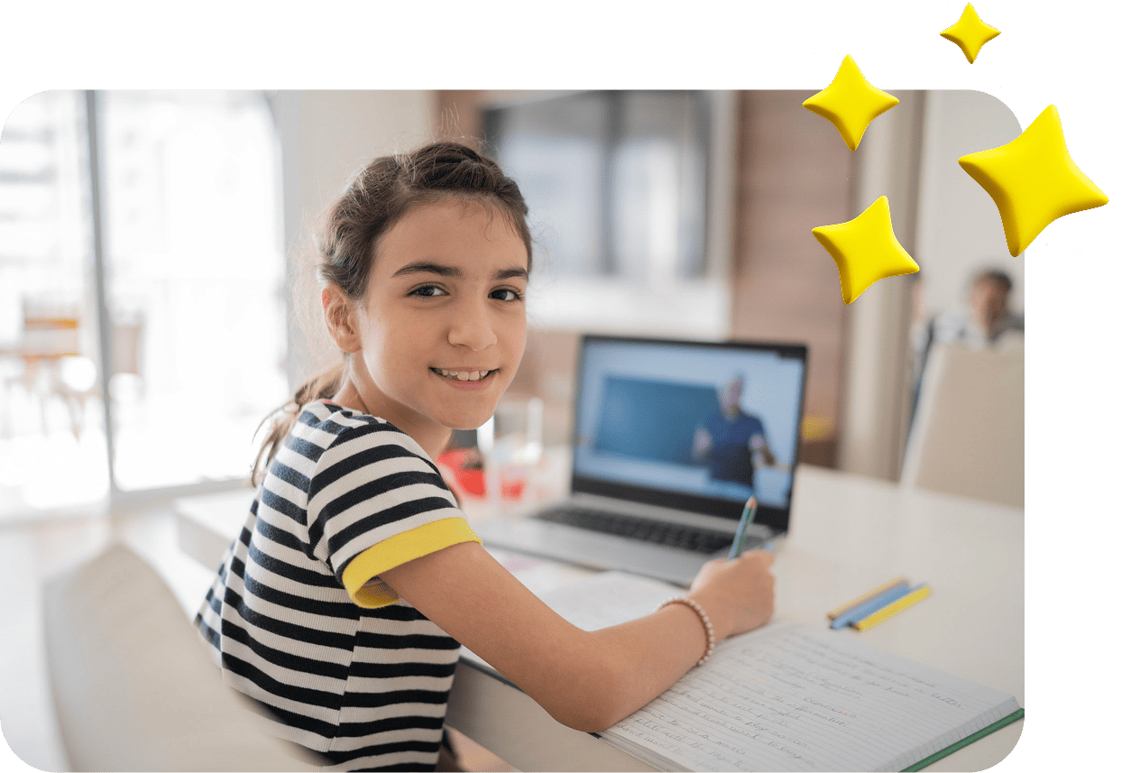 A smiling girl in a striped shirt writes in a notebook while looking at a laptop. The screen shows an online lecture. Bright, cheerful atmosphere.