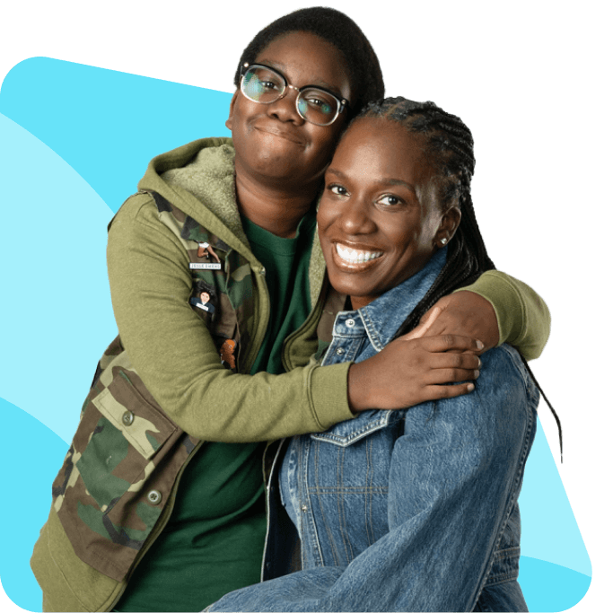 A young person in glasses hugs an adult who smiles warmly. The young person wears a green camo jacket; the adult is in a denim jacket. The background is a mix of black and light blue shapes, conveying a joyful, affectionate mood.